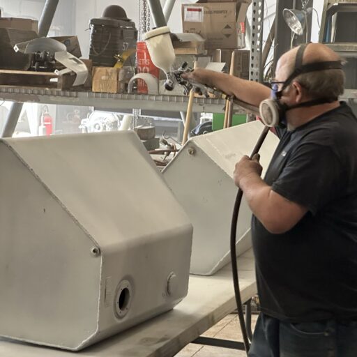 Volunteer Mike Creedon paints components of the interior of the M36 Jackson.