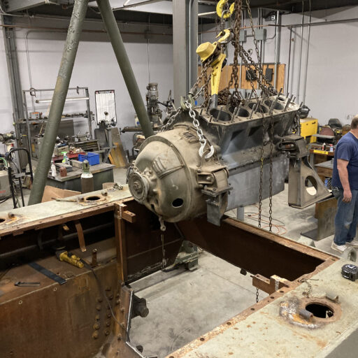The test core Ford GAA engine for the reconstruction of the engine compartment goes in for a test fit.