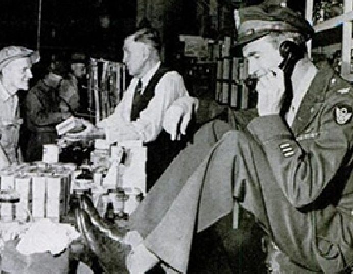 WWII serviceman on a phone at a military exchange counter