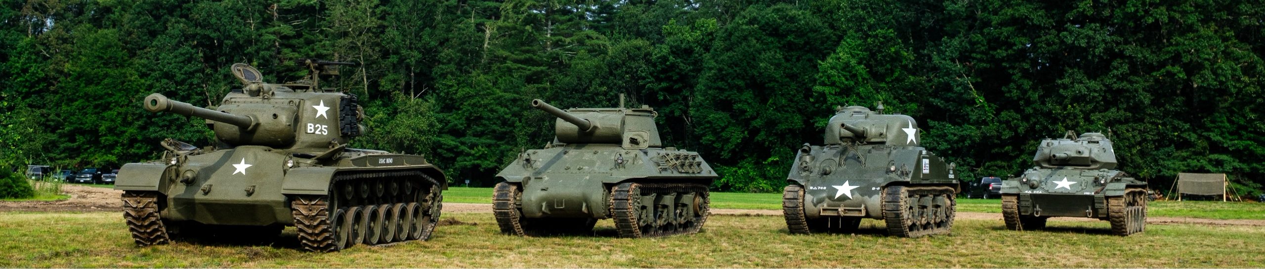 World War II tanks lined up on the field including the M4 Sherman, M36 Jackson and M24 Chaffee