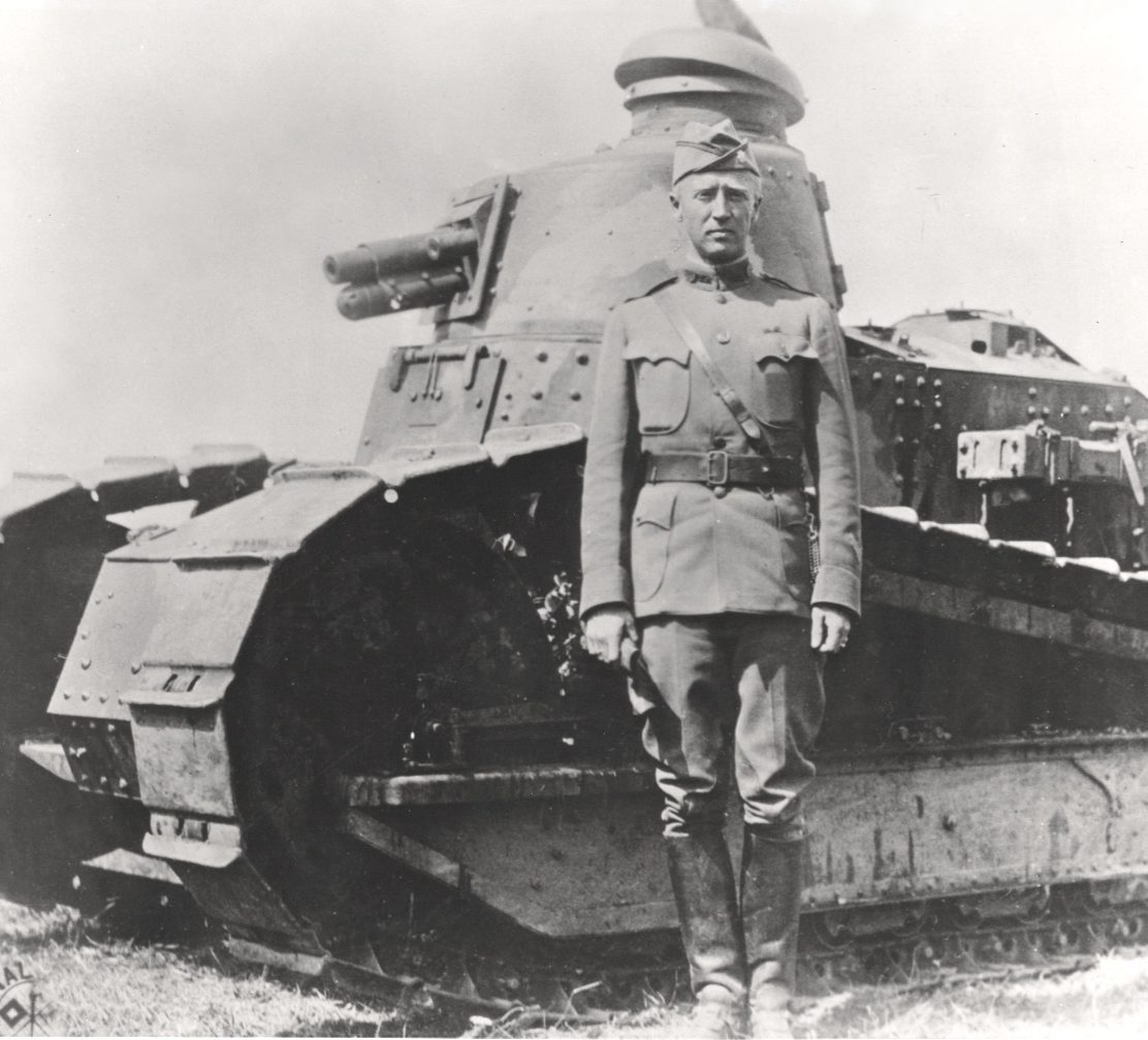 Historic photograph of a US Army officer standing beside an M1917 tank